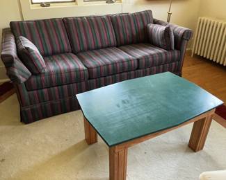 The sleeper Sofa is navy, green and burgundy…in excellent condition. The table has a green laminate top