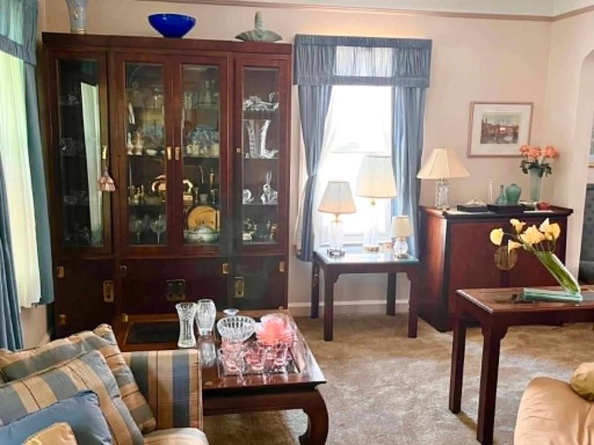 Beautifully Furnished Living Room Featuring matching Drexel Heritage furniture, crystal, artwork, home décor, and additional collectibles throughout the home.