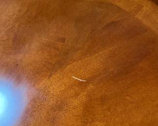 tiny scratch which could be easily concealed. We just wanted to point out.  less than a half inch and not deep.