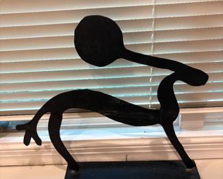Metal sculpture on wrought iron base