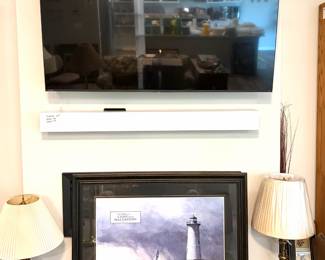 Toshiba 65” QLED 4K smart TV and a framed art print titled "Out After The Storm" by David Knowlton.