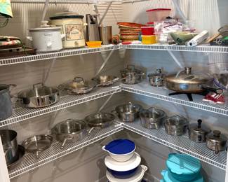 Stainless steel cookware including Emeril pots/pans, crockpots, and other small kitchen appliances. Brand new silverware/flatware sets, Tupperware and food storage containers 