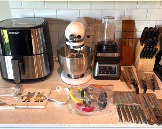 KitchenAid mixer, a Chefman stainless steel air fryer, a Ninja blender, sets of Cutco knives and a wooden knife block.
