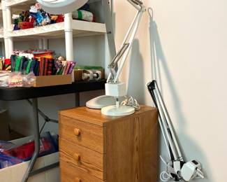 a clamp-on LED magnifying desk lamp and a 3 drawer wooden storage chest