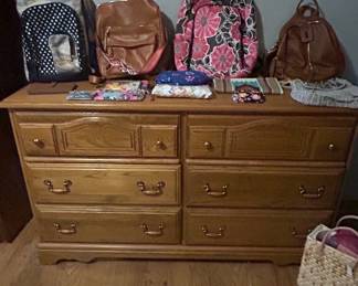 Wooden Dresser with Backpacks and Accessories