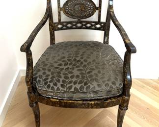 A pair of faux tortoise shell chairs