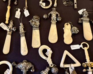 Collection of antique baby rattles, many with sterling silver and mother of pearl