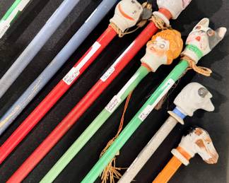Carnival prize canes with painted figural heads, including clowns, animals and others