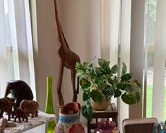 Tall and slender wooden giraffe.  