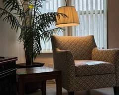 Need a place to get away? Try this set up for a relaxing moment or two. Comfortable chair, reading lamp and flora decor!