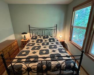 Black Metal Scroll Bed Frame with Geometric Quilt