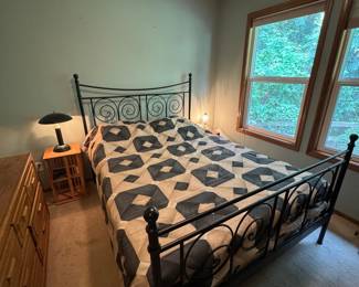 Black Metal Scroll Bed Frame with Geometric Quilt