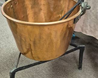 Large copper kettle with cast iron stand
