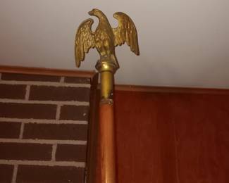 Brass eagle finial, flag pole and cast iron holder 