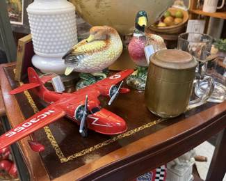 globe, vintage wood side table, airplane, duck figurines, lamp