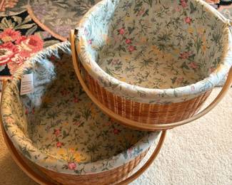 C63 - $60. Pair of Claire Murray Nantucket Style Market Baskets with floral fabric liner & handles. Large basket is 14" x 7.5". Smaller is 11" x 5.5" tall.