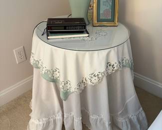 C38 - $25. Glass Top Bedside Table with Shelf. Includes linens.