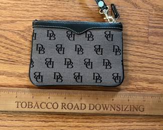 C13 - $20. Dooney & Bourke Black Signature Wristlet. Measures 6" x 4".