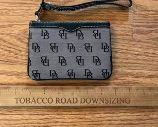 C13 - $20. Dooney & Bourke Black Signature Wristlet. Measures 6" x 4".