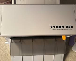 C64 - $20. Xyron 850 Laminating System. Has laminating paper loaded, an extra cartridge and a 2" & 4" adhesive runner with refills.