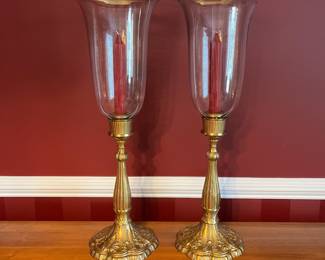 C26 - $50. Pair of Vintage Brass Candle Holders with tall glass hurricane shades. Measures 9.25" wide x 27.25' tall.