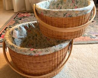 C63 - $60. Pair of Claire Murray Nantucket Style Market Baskets with floral fabric liner & handles. Large basket is 14" x 7.5". Smaller is 11" x 5.5" tall.