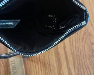 C13 - $20. Dooney & Bourke Black Signature Wristlet. Measures 6" x 4".