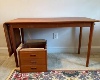 C18 - $650. Arne Vodder for H. Sigh & Sons. Teak Drop Leaf Writing Desk. Measures 48" x 23.5" x 28" tall. (65" with leaf up) Needs minor repairs and has light surface blemishes.