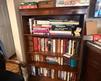 medium sized mahogany book case with books