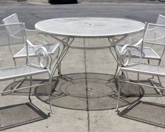062 Lot 164 Hollywood Regencystyle metal mesh patio table and four armchairs