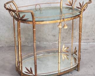 100 Lot 100 Hollywood Regency giltmetal tiered table with glass and mirrored top