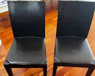 TWO OF SIX LEATHER AND WOOD DINING CHAIRS