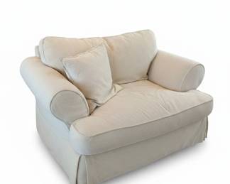 Cream Upholstered Armchair with Loose Pillow and Skirted Base
