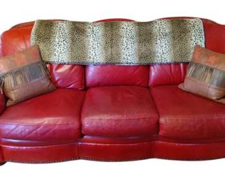 Vintage Red Leather Couch With Pair Of Leather Pillows and Leopard Colored Blanket