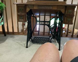 Antique Singer sewing machine in cabinet