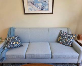 Sofa with powder blue tailored fabric upholstery