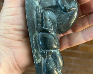 inuit hand carved figurine of hunter on a sled with dogs