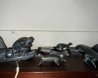 inuit hand carved figurine of hunter on a sled with dogs