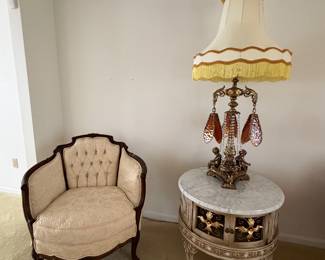 One of two Victorian barrel chairs, Italian marble top table and vintage Loevsky & Loevsky Hollywood Regency lamp with Strauss crystals.
