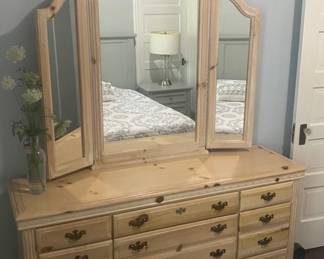 vintage Broyhill Fontana triple dresser features a natural pine finish and a matching tri-fold mirror