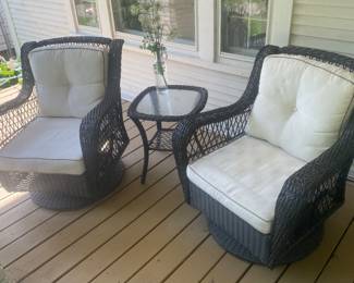 Pair of swivel faux wicker patio chairs
