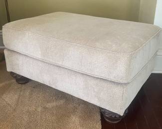 Upholstered ottoman with bun feet