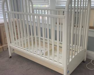 White baby crib on wheels