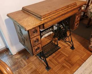 Antique Singer sewing machine w cabinet. $150.00
