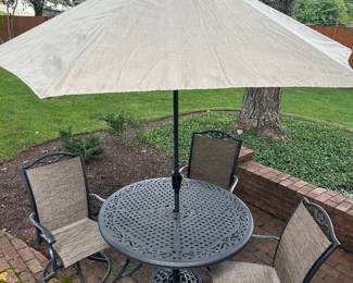 Metal patio table and 3 swivel chairs and umbrella