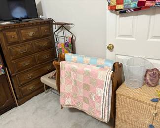 chest of drawers, wicker trunk, quilts