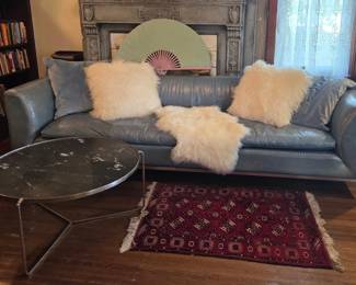 9ft long MCM-70's leather sofa on chrome frame, marble top chrome coffee table, lambswool pillows and faux throws, smaller wool area rug