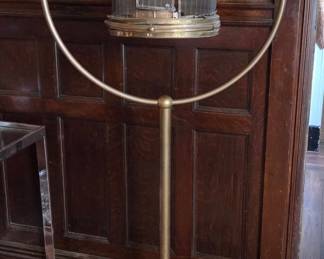 An antique brass birdcage and stand