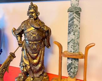 Chinese god of wealth and prosperity next to a very rare snowflake jade sword.