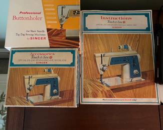 Accessories and instructions for Singer sewing machine.